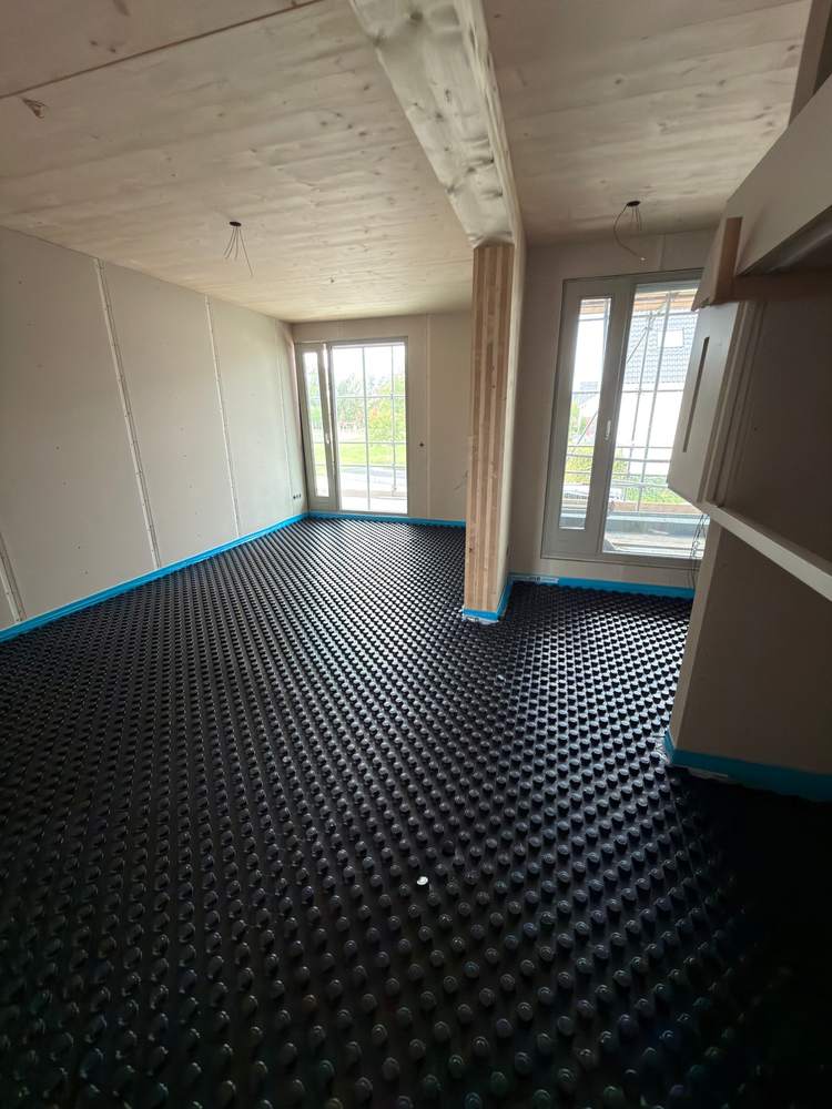 2 · Ready for the pipe — Living room fully laid — the stud grid sets the pipe spacing.